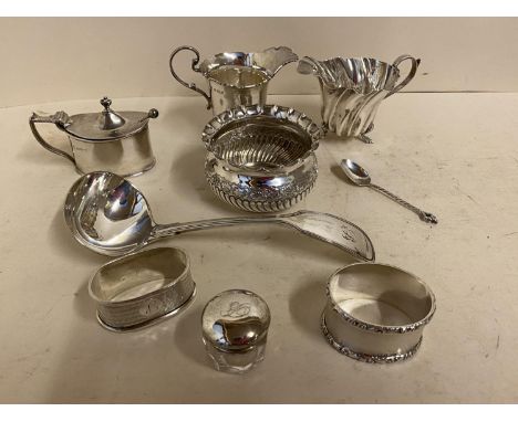 9 small Hallmarked silver cabinet pieces including 2 cream jugs, ladle, spoon, napkin rings, mustard with blue glass liner an