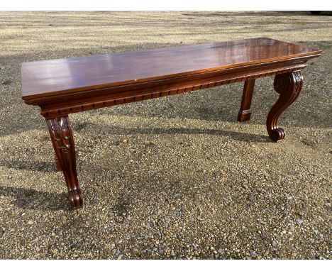 Good George III heavy figure mahogany oblong console serving table, with a carved under frieze on 2 heavy scrolling and carve