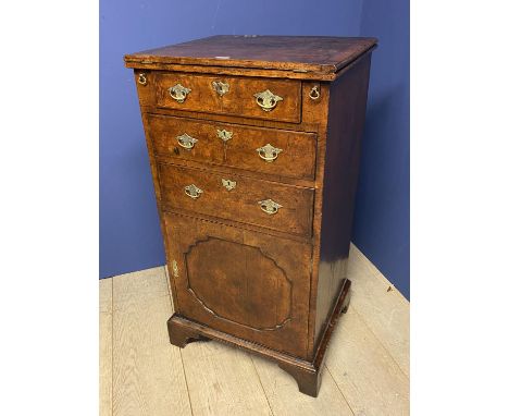 George ll. walnut fold over bachelors chest with three graduated drawers above a cupboard door, on bracket feet 