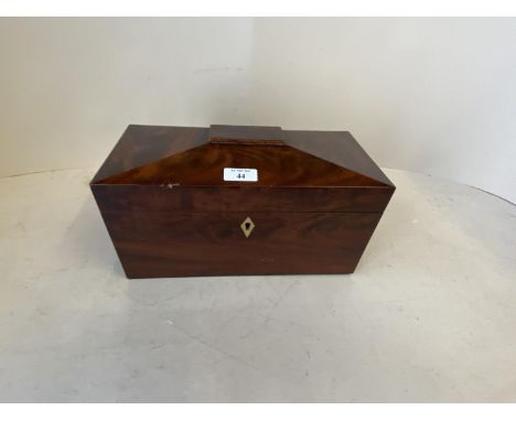 Figured mahogany tea caddy with lion mask ring handles and fitted interior with glass mixing bowl.  Condition chip to top edg