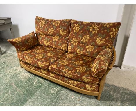 ERCOL&nbsp; sofa with orange cushions, 204cmW x 85cmD x 94cm H, and a red upholstered wing chair and a stick back chair