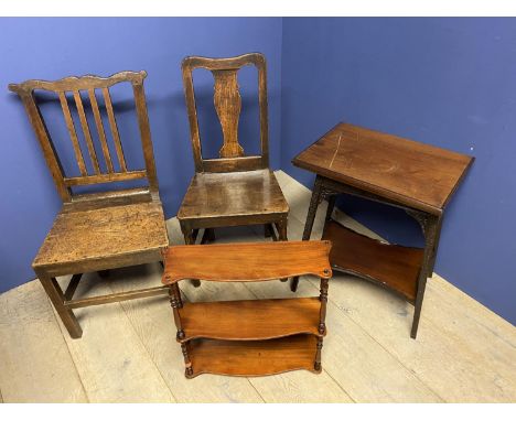 Two oak solid seat hall chairs, a mahogany hanging shelf, and a mahogany swivel top games table, with interior 