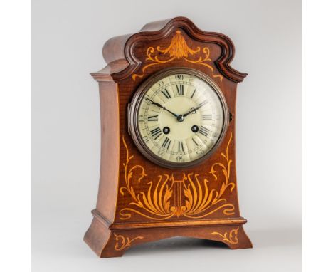 AN EDWARDIAN MAHOGANY AND SATINWOOD MARQUETRY-INLAID MANTEL CLOCKCirca 1900The arched case of gently spreading form, inlaid t