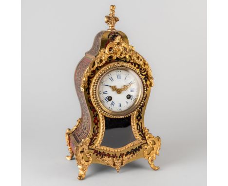 A FRENCH GILTMETAL-MOUNTED BOULLE MANTEL CLOCKIn the Louis XV style, circa 1880The waisted case surmounted by an urn, on scro