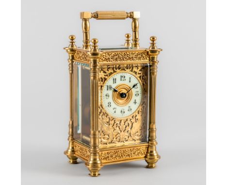A FRENCH BRASS CARRIAGE TIMEPIECECirca 1900The case with a reeded handle above four turned finials, and foliate bands between