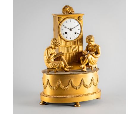 AN EMPIRE ORMOLU MANTEL CLOCKBy Vauchar, Paris, circa 1815Modelled with two students reading, seated each on a stool, a recta