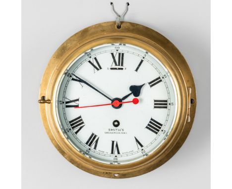 A BRASS BULKHEAD TIMEPIECEBy Smith’s, Cricklewood, NW2With 7in circular enamelled dial (restored), sweep red seconds hand and