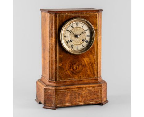 A FRENCH ROSEWOOD AND BRASS LINE-INLAID MANTEL CLOCKThe rectangular case with a plain top above canted angles, above a steppe