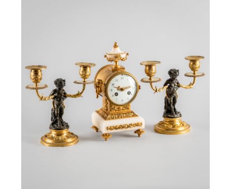A FRENCH ORMOLU, MARBLE AND BRONZE COMPOSITE GARNITUREIn the Louis XVI style, Late 19th CenturyComprising a mantel clock and 