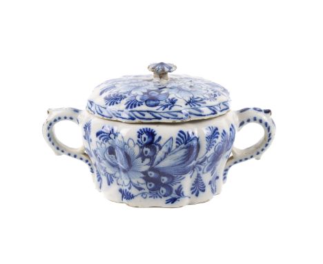 A Delftware lidded pot. Possibly 17th century, of squat baluster form with twin handles, glazed in white with blue floral dec