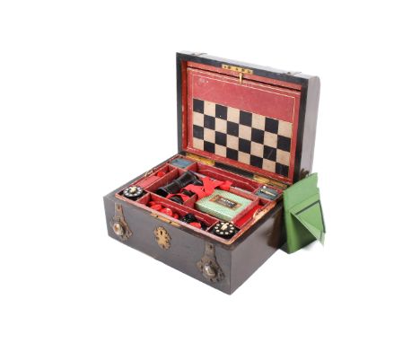 A Victorian burr wood games compendium stamped M A Ellett, Plymouth. The case exterior with Gothic style brass bindings set w