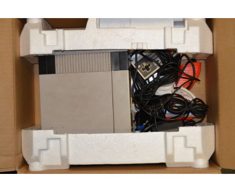 A Nintendo Nes Console, complete with power supply, two controllers and a gun, untested