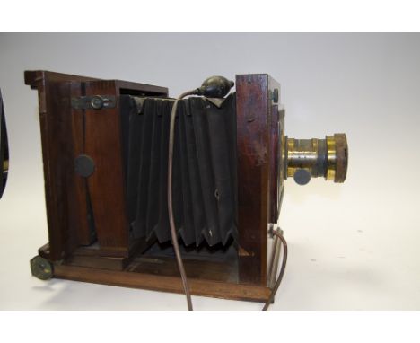 A Mahogany and Brass Studio Camera,  with tilt and swing back, square cornered fabric bellows, CEO Houghton & Son Holborn Spe