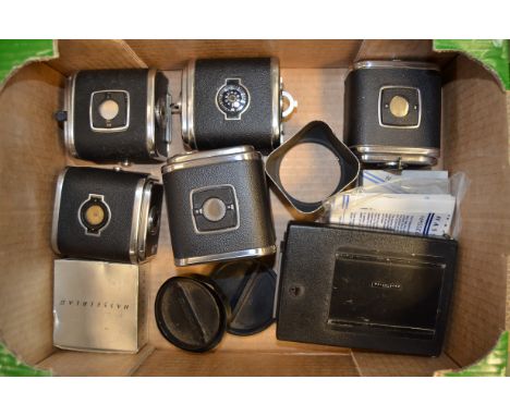 A Tray of Hassleblad V-Series Accessories, including a A70 film back, A12 film backs (4), a polaroid back, lens hoods, and a 