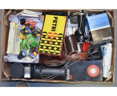 A Tray of Canera Accessories, including, filters, lenses, flash units, light meters and some 35mm film.