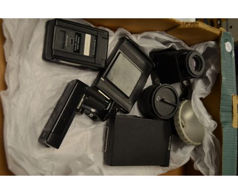 A Tray of Medium Format Accessories,  a Hassleblad H 1.7x Converter, and Polaroid back, a Rolleiflex 6006 120 fillm magazine,