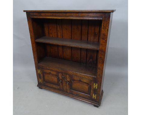 A stained oak open bookcase, with single adjustable shelf and cupboards under, 84cm x 97cm x 27cm 