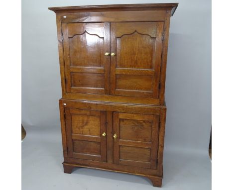 An 18th Century oak 4-door house maids cupboard, with shelf-fitted interior, on bracket feet, 112cm x 174cm x 51cm 