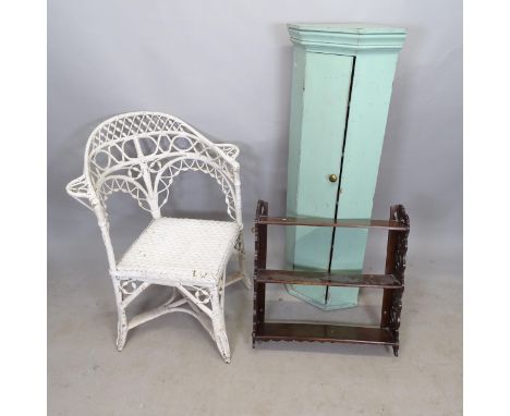 A wicker corner conservatory armchair, a mahogany hanging shelf, and a painted wooden corner cupboard (3) 