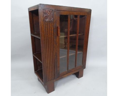 An Arts and Crafts oak cabinet with single-glazed door, and shelf-fitted side, 69cm x 97cm x 32cm 