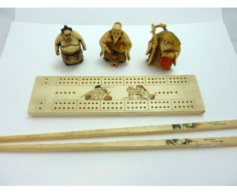 THREE CARVED IVORY NETSUKE, a Sunio Wrestler and two immortals, together with a pair of chopsticks and a gaming score counter