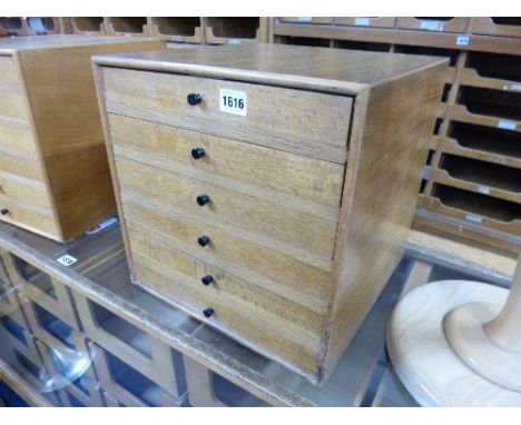 A SMALL LIGHT OAK COUNTER TOP CHEST, of six drawers
