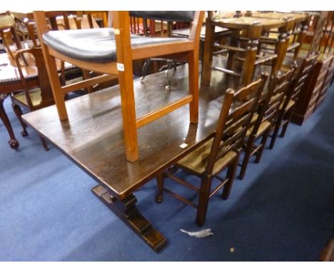 AN OAK REFECTORY TABLE, with later made extension section and eight ladder back rush seated chairs (s.d.) (10)