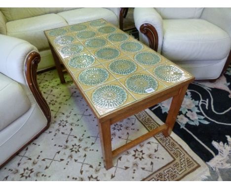 A TEAK TILE TOPPED COFFEE TABLE