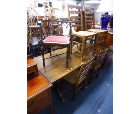 AN OAK DINING TABLE, and six rush seated ladder back chairs (7)
