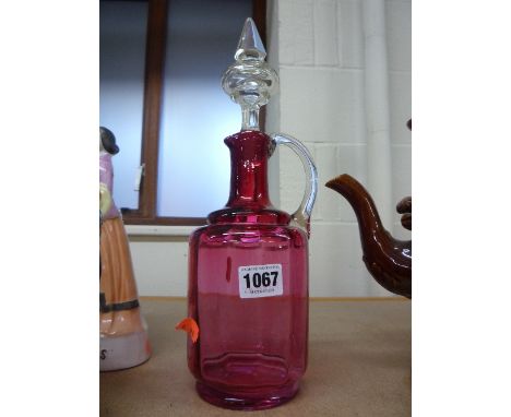 A RUBY GLASS DECANTER AND STOPPER
