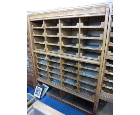 A LIGHT OAK WALL STANDING SHOP STORAGE CABINET, with 36 drawers of various sizes above a lower double compartment (s.d.) (not