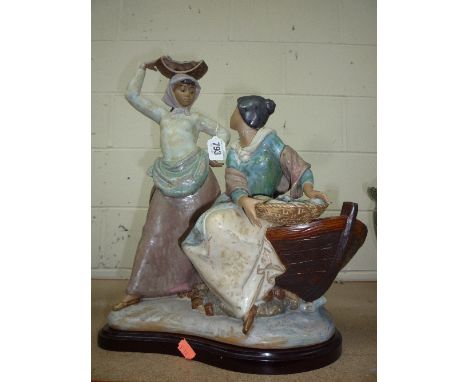 A LLADRO DISTRESSED FIGURE GROUP, matt glazed, depicting two women with fish by boat