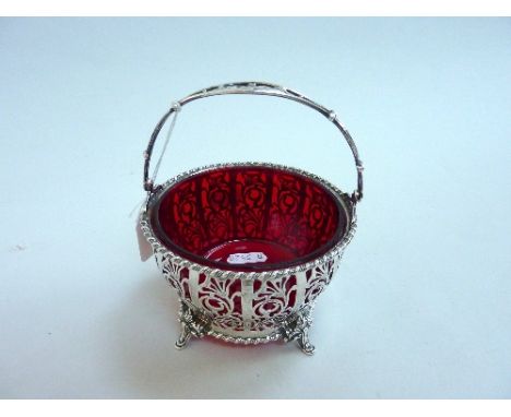 A GEORGE V ADIE BROS SILVER AND RED GLASS LINED SWING HANDLE BASKET, Birmingham 1935