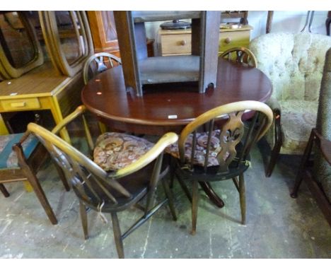 A MODERN CIRCULAR TABLE, and four Ercol chairs including one carver (5)