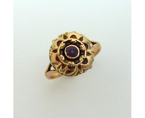 A VICTORIAN RING, the central circular amethyst with decorative scalloped surround to the two pronged tapered rose gold band,