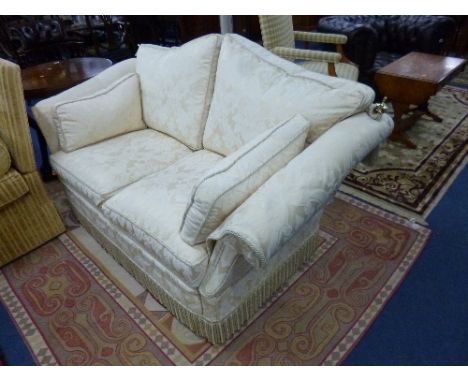 A KNOLL STYLE TWO SEATER SOFA, with cream floral embossed upholstery