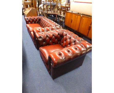 A RED LEATHER CHESTERFIELD SOFA, and matching armchair (s.d.) (2)