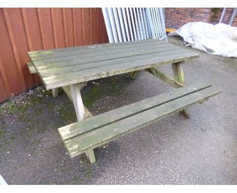 A LARGE WOODEN PICNIC BENCH