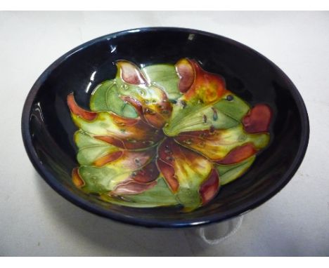 A SMALL MOORCROFT POTTERY TRINKET DISH, with Lily design on blue ground, diameter 11cm