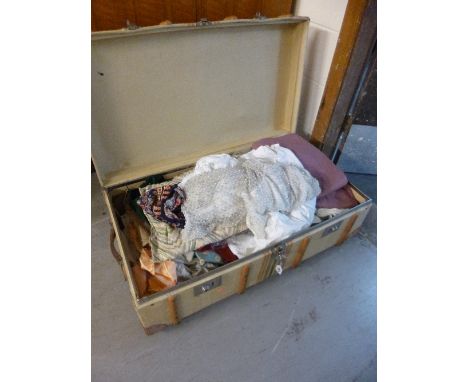 A TRAVELLING CABIN TRUNK, bearing various paper labels, including Monte Carlo together with a quantity of material remnants/o