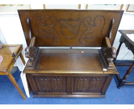 A CARVED OAK AND LINENFOLD MONKS BENCH