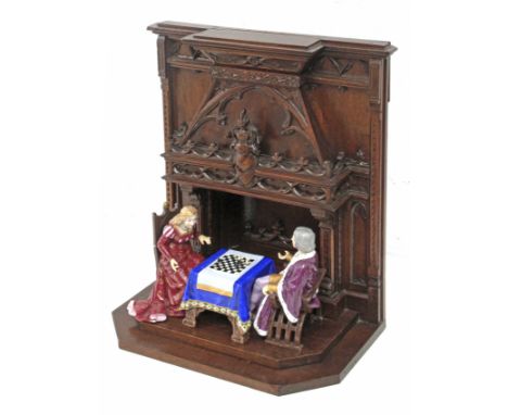 with a neogothic style wood structure and two porcelain figurines depicting Catholic monarchs of Spain playing chess- Lámpara