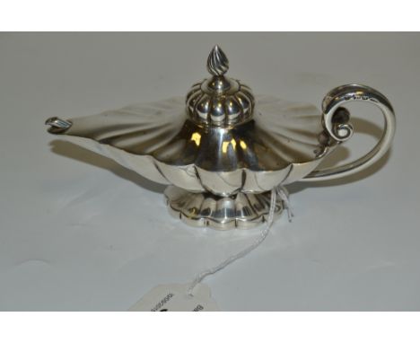 A 19th century Anglo-Indian silver lamp shaped table cigar lighter, fluted, spiral knop finial, divided scroll handle, spread