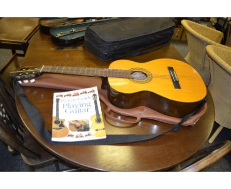 An KCC 353 classical guitar, an instruction manual on how to play the guitar