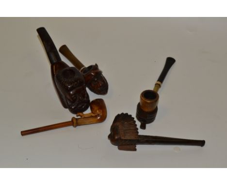 An early 20th century novelty pipe, as a pair of bellows; another, as a Native American; others (6)