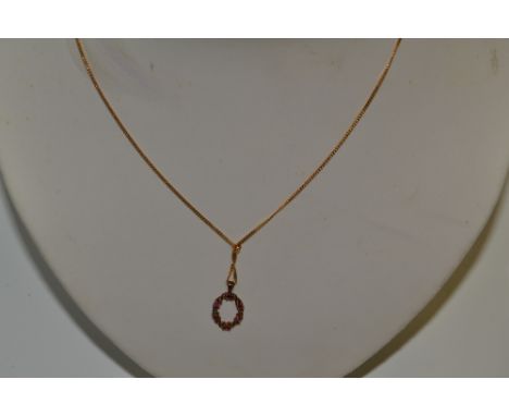 A 9ct gold and ruby pendant necklace, 2.6g