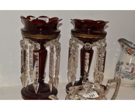 A pair of Victorian ruby glass lustres, spreading circular bases, 26cm high 