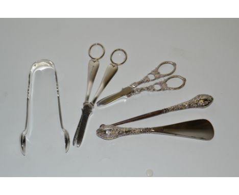 A pair of Victorian Provincial silver sugar tongs, James & Josiah Williams, Exeter 1855; a silver hafted button hook and shoe