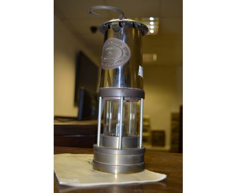 A twentieth century reproduction Eccles miners lamp; information booklet en suite (2)
