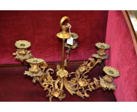 A 19th century ormolu five-light chandelier, posted suspension loop, campana sconces and branches cast with scrolling acanthu
